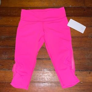 Lululemon Athletica cropped hot pink leggings.